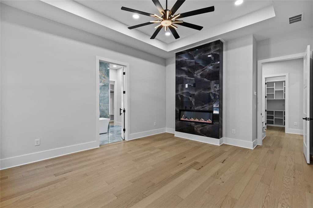 1198 Peters Cemetary Road Monroe, GA 30655 - Photo 22 of 64 a view of an empty room with a window and wooden floor