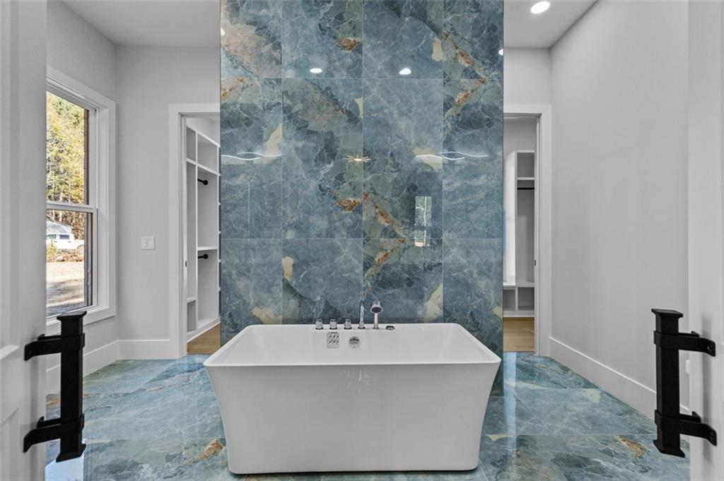 1198 Peters Cemetary Road Monroe, GA 30655 - Photo 24 of 64 a bathroom with a bathtub and shower