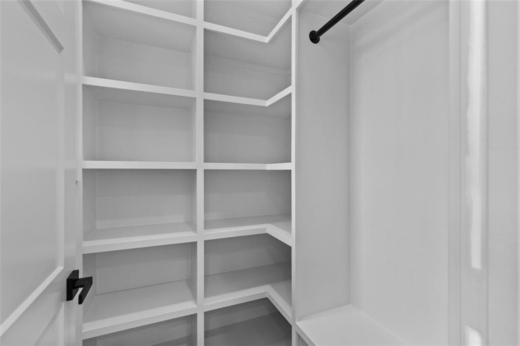 1198 Peters Cemetary Road Monroe, GA 30655 - Photo 35 of 64 a view of walk in closet with empty racks