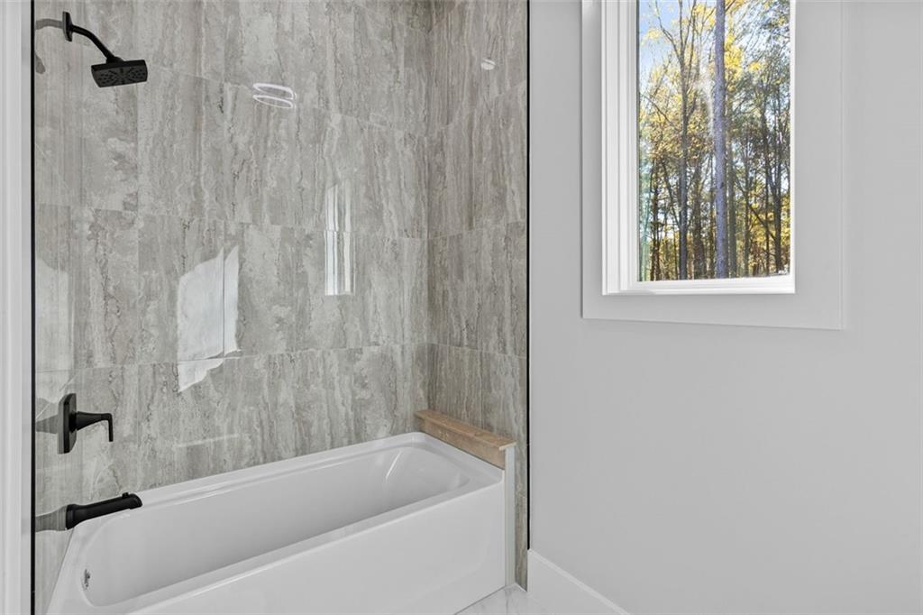 1198 Peters Cemetary Road Monroe, GA 30655 - Photo 38 of 64 a bathroom with a bathtub and shower