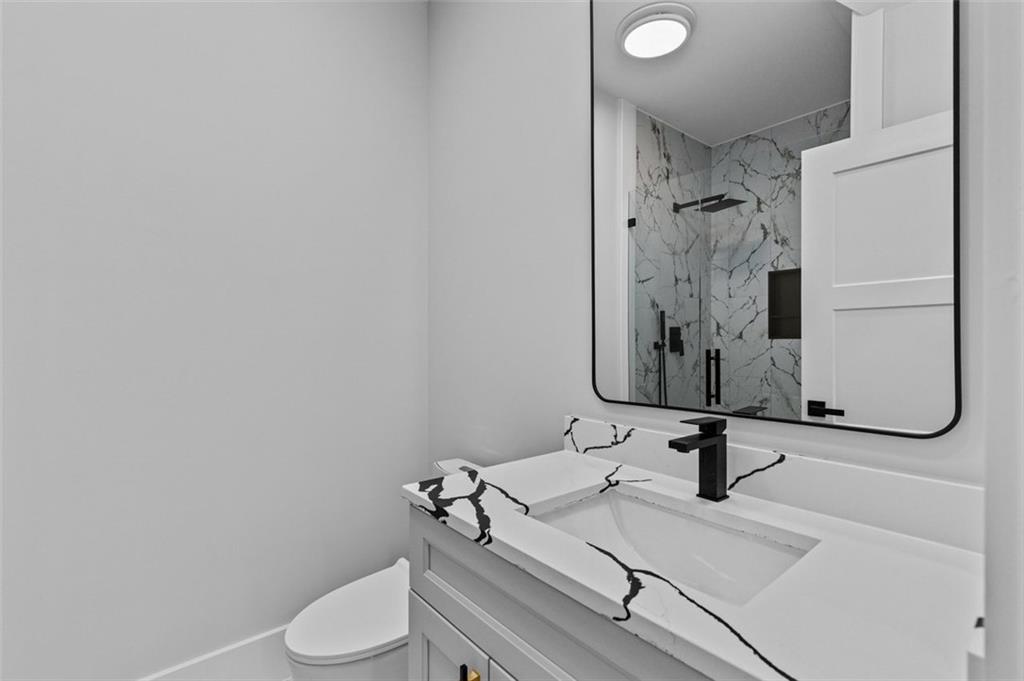 1198 Peters Cemetary Road Monroe, GA 30655 - Photo 50 of 64 a bathroom with a toilet sink and mirror