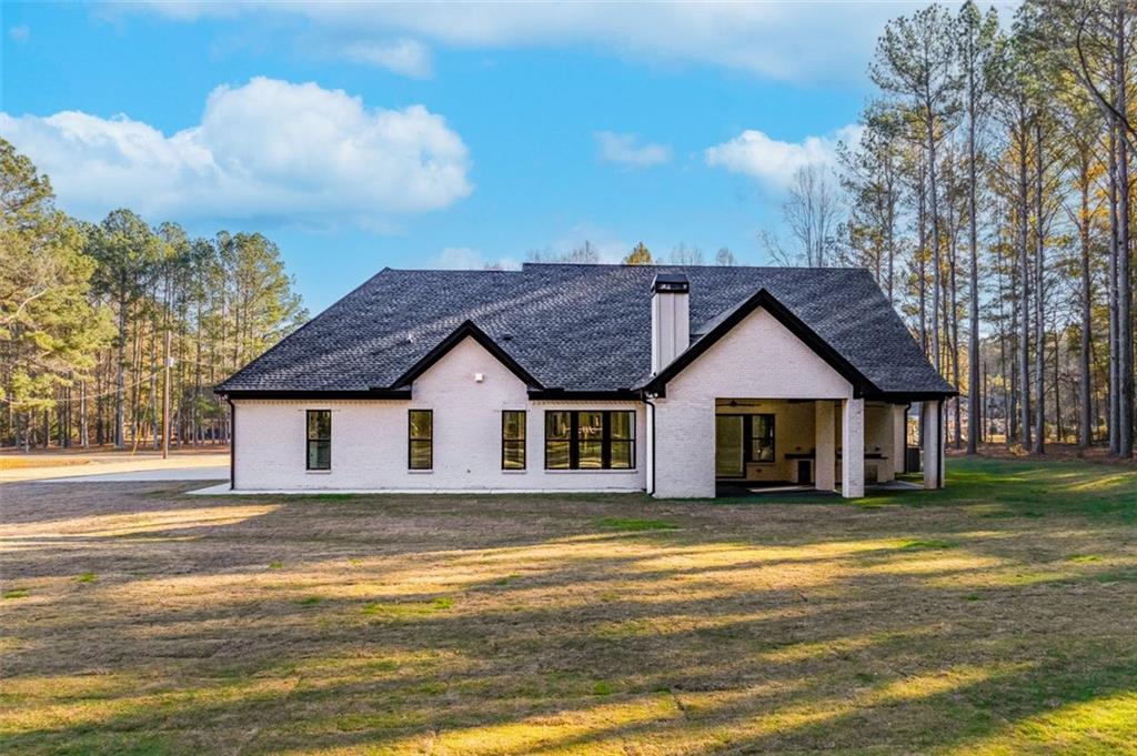 1198 Peters Cemetary Road Monroe, GA 30655 - Photo 60 of 64 a view of a house with a big yard and large trees