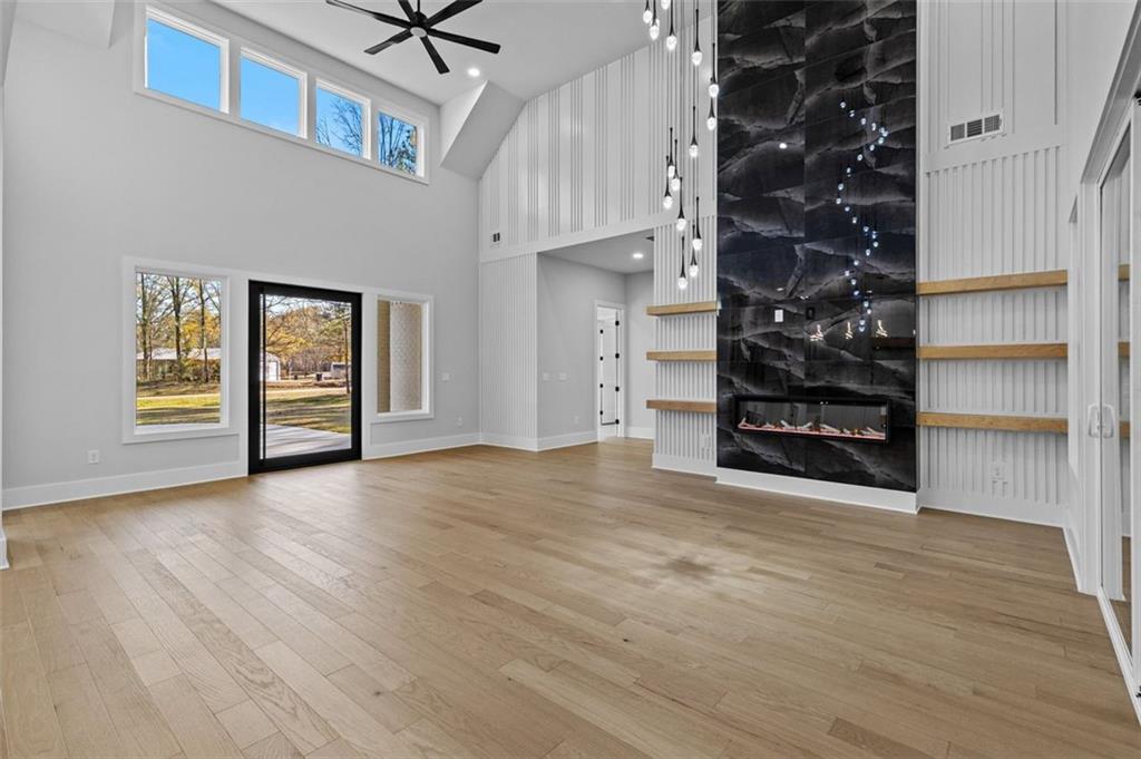 1198 Peters Cemetary Road Monroe, GA 30655 - Photo 9 of 64 a view of an empty room with a window and wooden floor