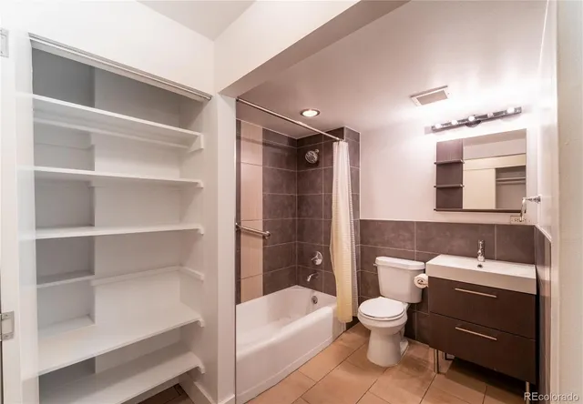 a bathroom with a sink a toilet and bathtub