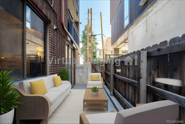 a view of balcony with two chairs and a potted plant
