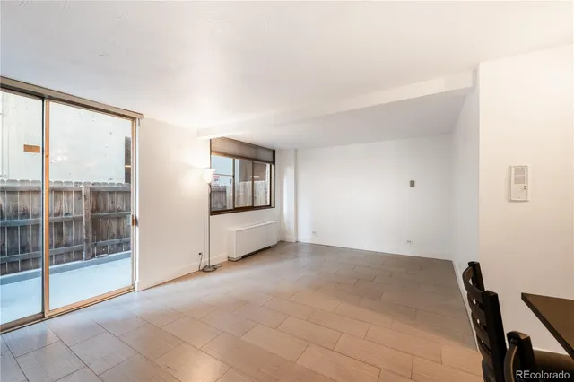 a view of an empty room with glass door