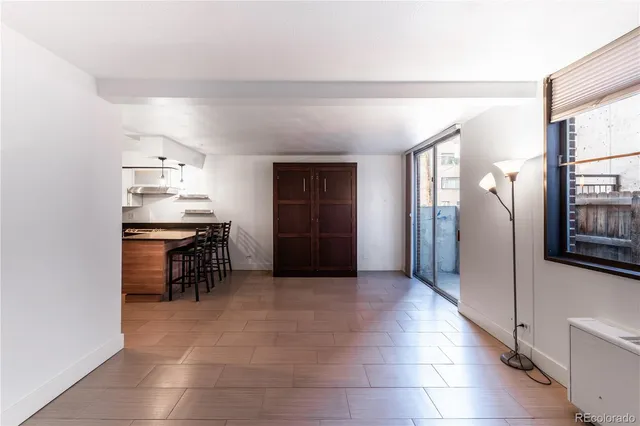 a view of kitchen with furniture and refrigerator