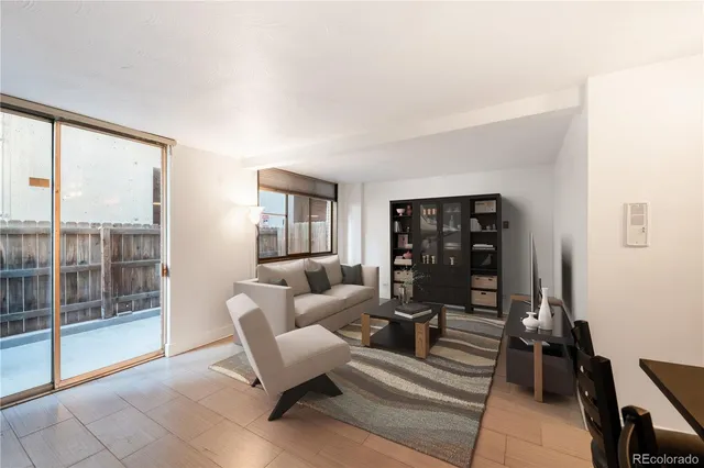 a living room with furniture and dining table with wooden floor