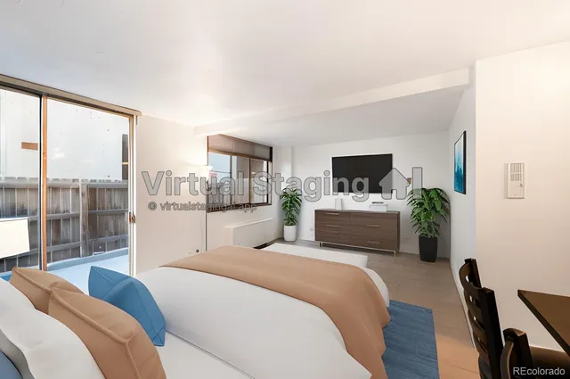 a bedroom with a large bed and a television