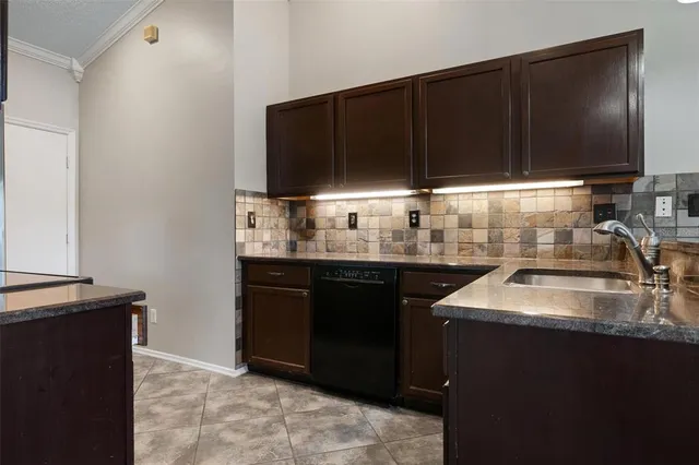 a kitchen with granite countertop a sink and a cabinets