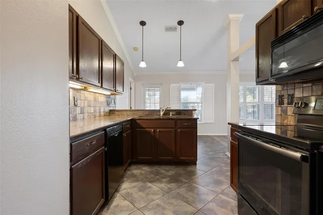 a kitchen with a sink stainless steel appliances and cabinets