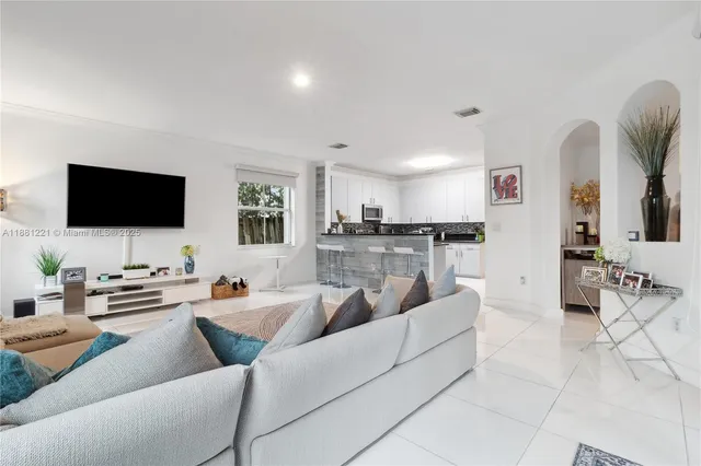 a kitchen with stainless steel appliances granite countertop a sink a stove and a microwave