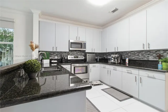 a view of a patio with table and chairs potted plants with wooden floor
