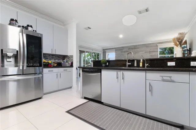 a view of a patio with couches table and chairs with wooden floor and fence