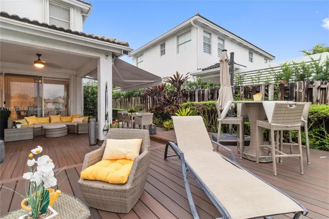 a bathroom with a sink a toilet a mirror and shower curtain