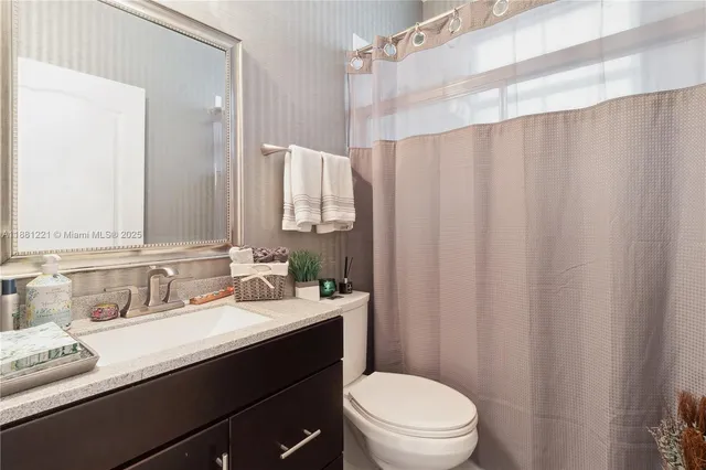 a bathroom with a toilet a sink and bathtub
