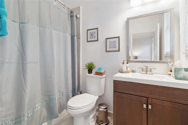 a bathroom with a double vanity sink a mirror and a bathtub