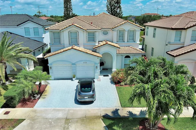 an aerial view of a house with garden space and street view