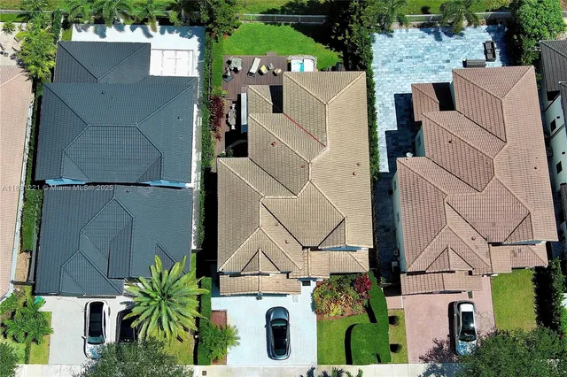 a view of a house with a yard and potted plants