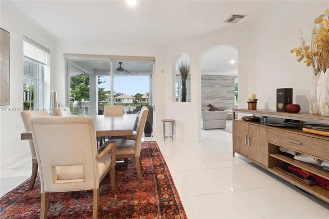 a dining room with furniture and large windows