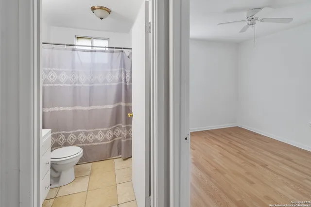 a bathroom with a granite countertop toilet and a shower