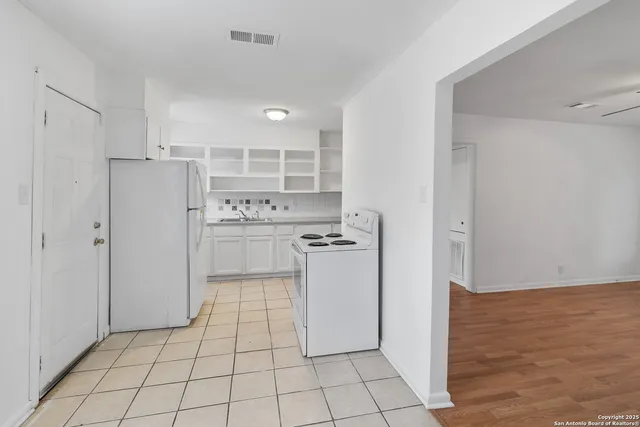a kitchen with stainless steel appliances a refrigerator and a stove