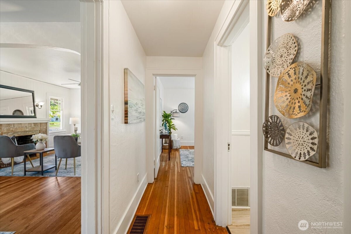4837 South I Street Tacoma, WA 98408 - Photo 12 of 40 a view of a hallway with wooden floor and furniture