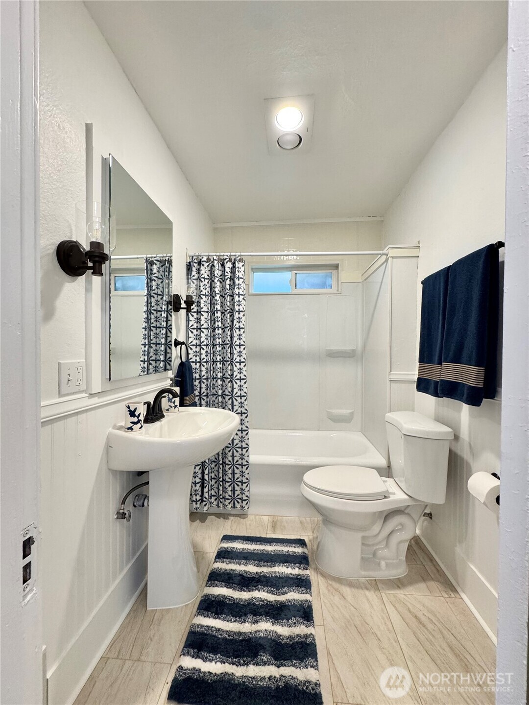 4837 South I Street Tacoma, WA 98408 - Photo 17 of 40 a bathroom with a sink toilet a mirror and shower