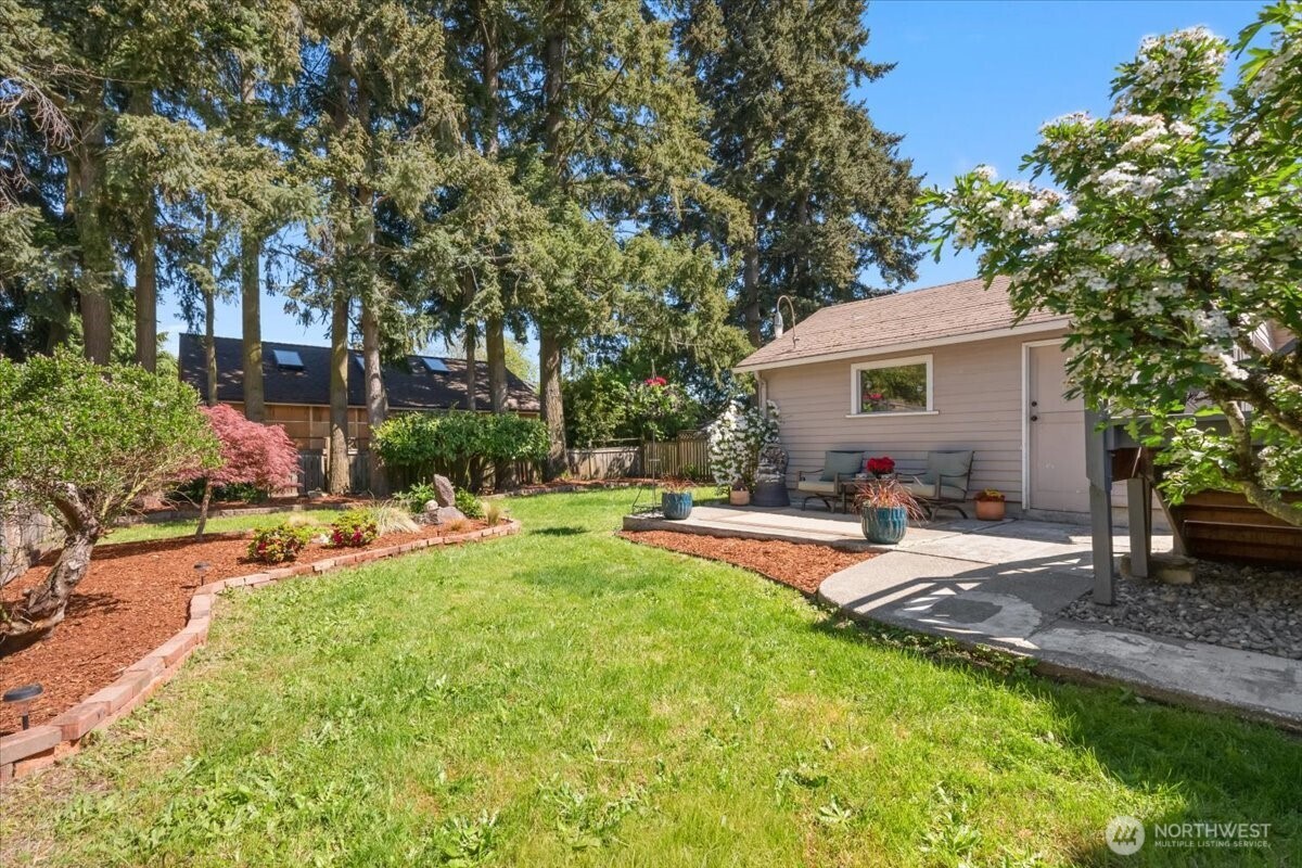 4837 South I Street Tacoma, WA 98408 - Photo 32 of 40 a view of a house with swimming pool and sitting area