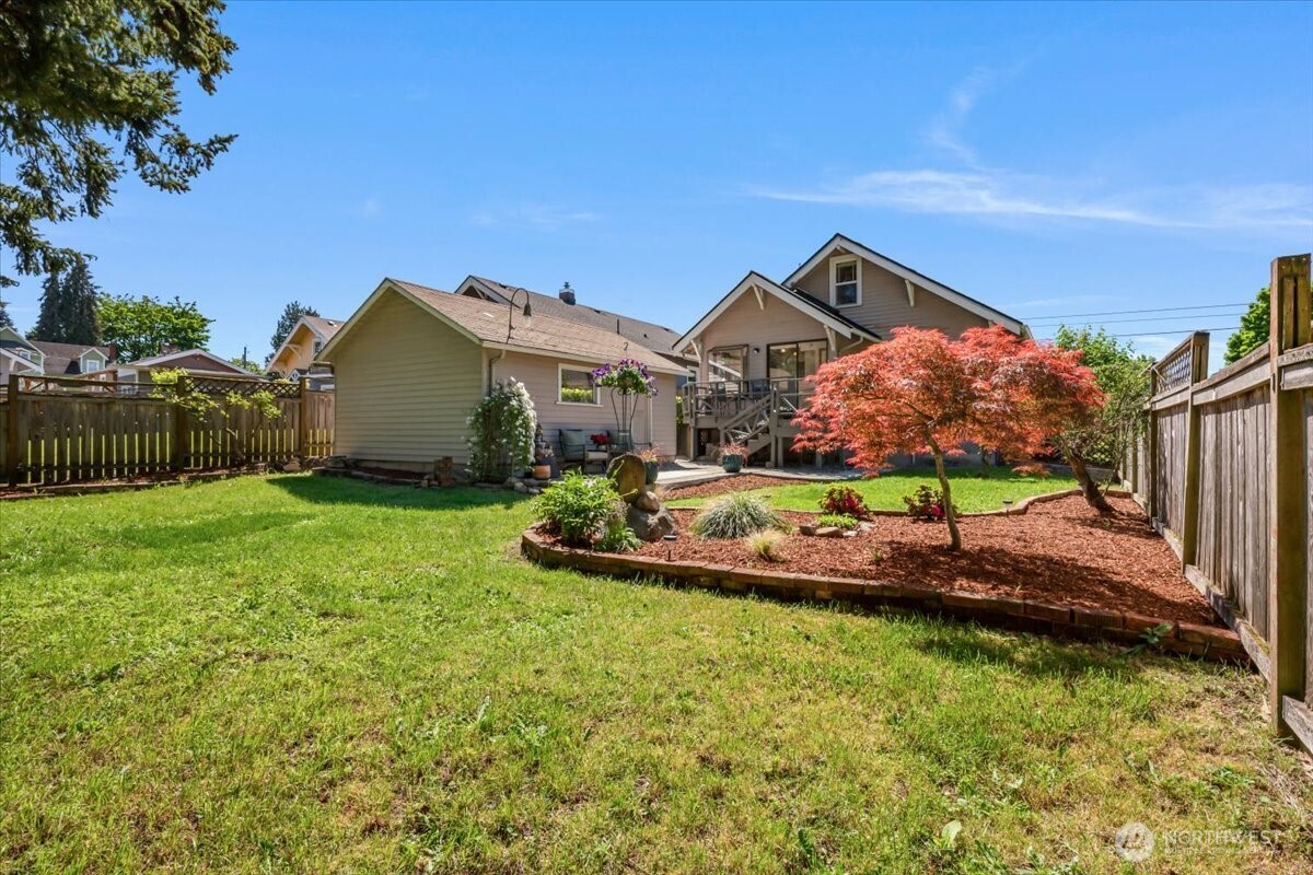 4837 South I Street Tacoma, WA 98408 - Photo 33 of 40 a view of a house with a big yard potted plants and large tree