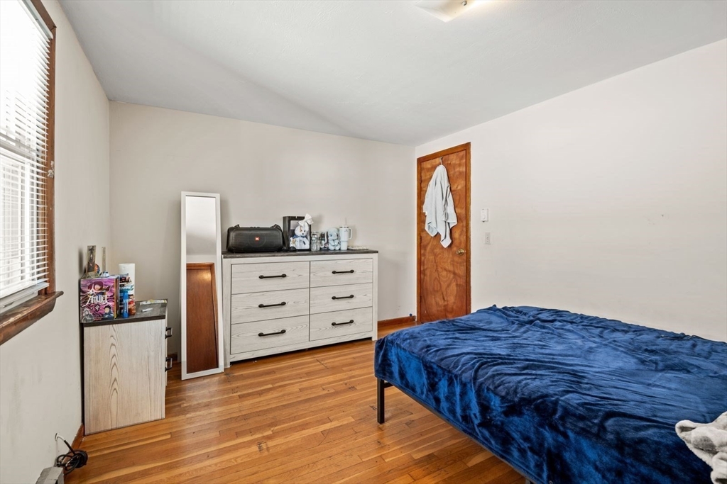 48 Hardwick Terrace Boston, MA 02135 - Photo 11 of 32 a bedroom with a bed and wooden floor