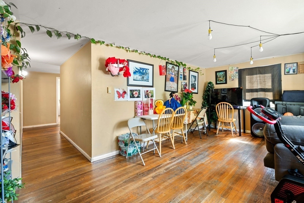 48 Hardwick Terrace Boston, MA 02135 - Photo 16 of 32 a view of a dining room with furniture wooden floor and a chandelier