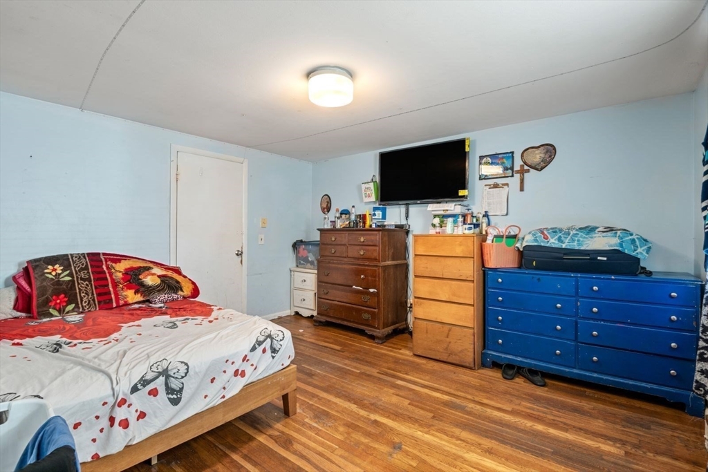 48 Hardwick Terrace Boston, MA 02135 - Photo 21 of 32 a bedroom with a bed and a flat screen tv