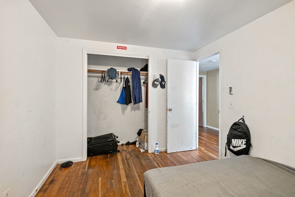 48 Hardwick Terrace Boston, MA 02135 - Photo 26 of 32 a bedroom with a bed and a wooden floor
