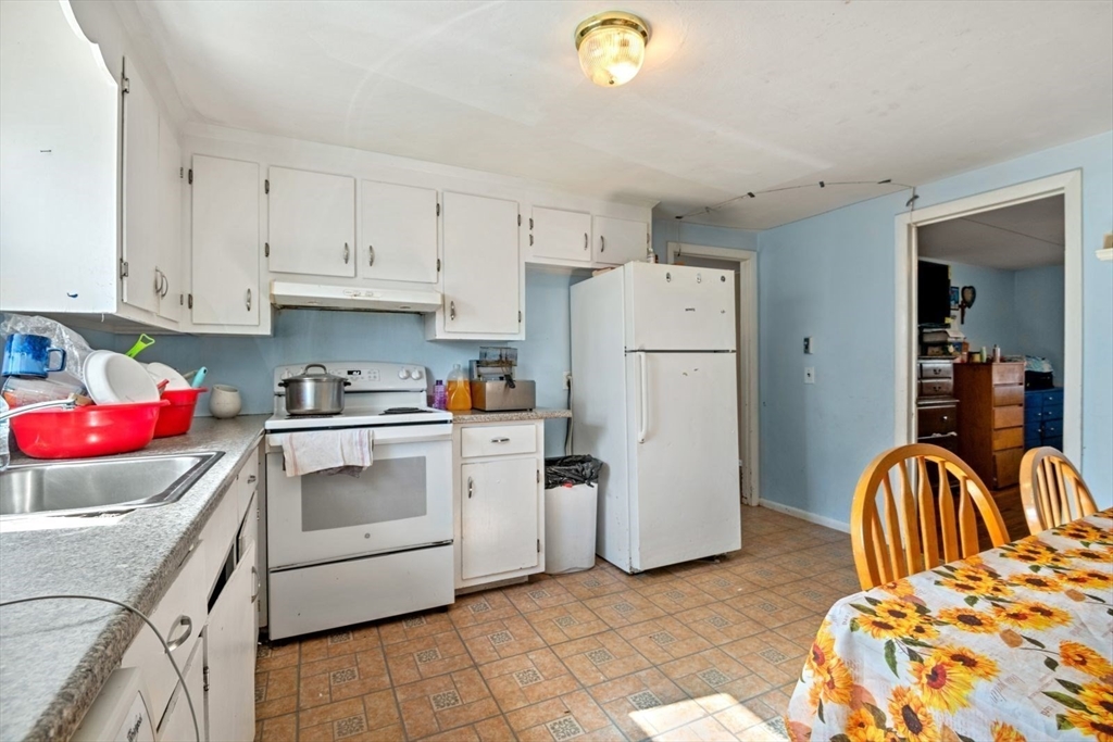 48 Hardwick Terrace Boston, MA 02135 - Photo 6 of 32 a kitchen with a refrigerator sink and cabinets