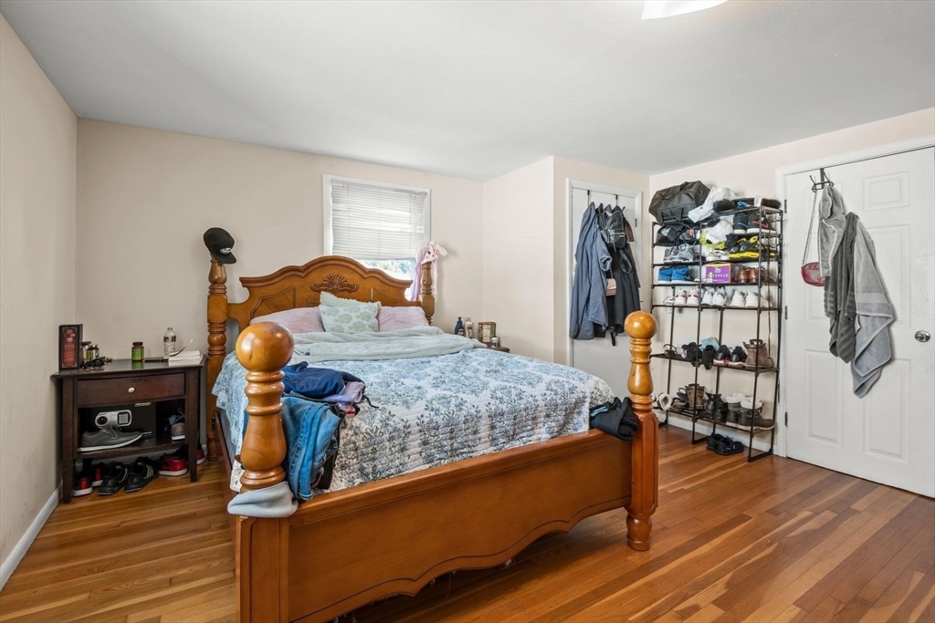 48 Hardwick Terrace Boston, MA 02135 - Photo 8 of 32 a bedroom with a bed and wooden floor