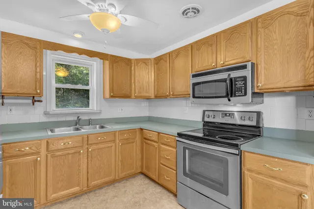 a kitchen with a sink cabinets and a window
