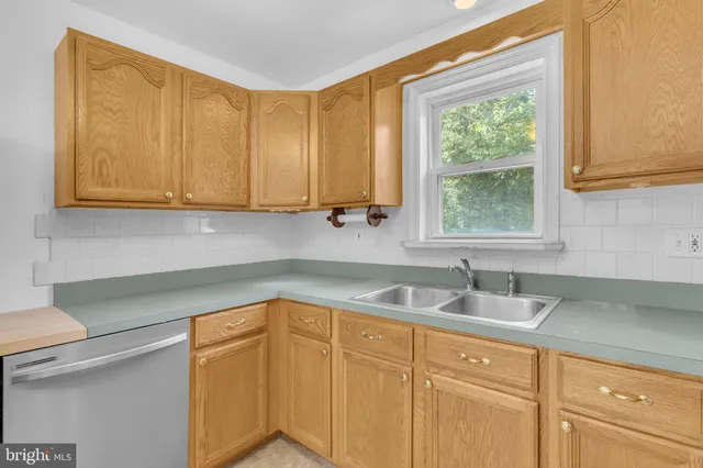 a kitchen with a sink cabinets and window
