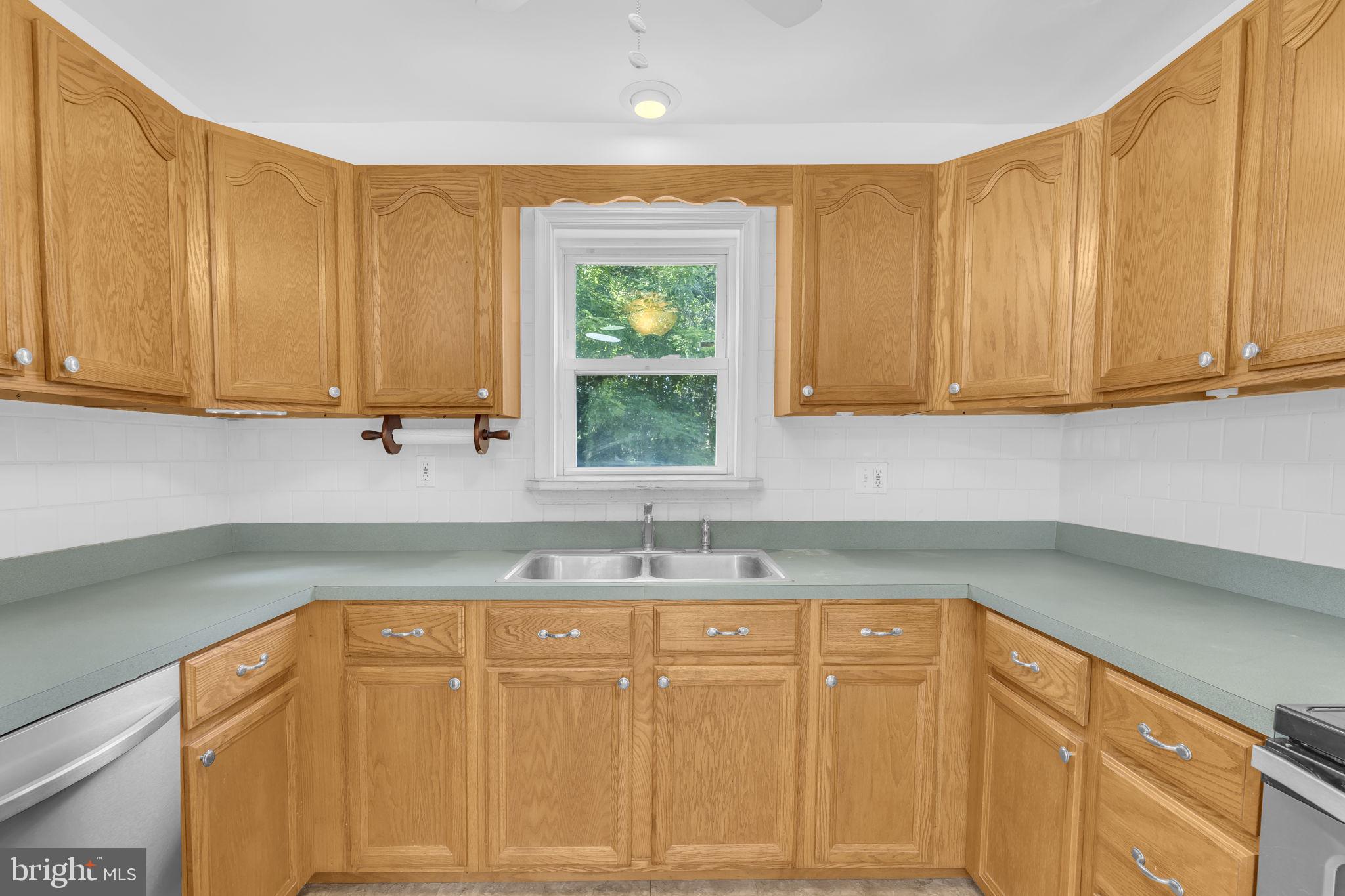 16500 Baden Naylor Road Brandywine, MD 20613 - Photo 15 of 37 a kitchen with a sink cabinets and window