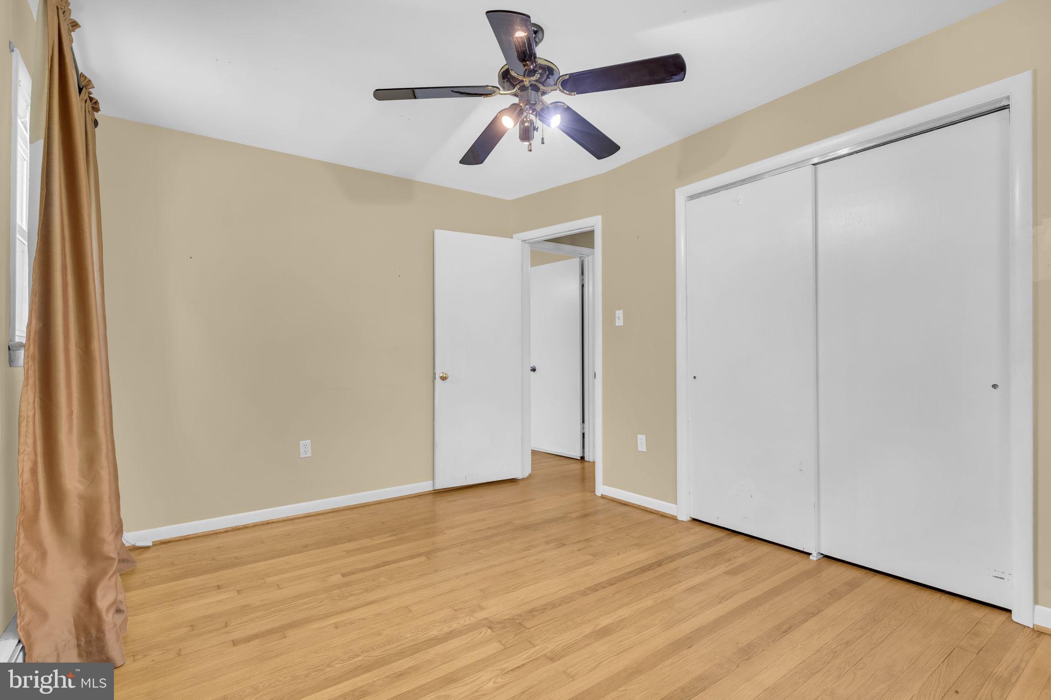 16500 Baden Naylor Road Brandywine, MD 20613 - Photo 19 of 37 a view of a room with a ceiling fan wooden floor and a ceiling fan