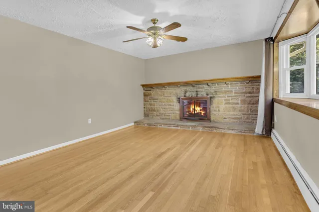 wooden floor in an empty room with a fireplace