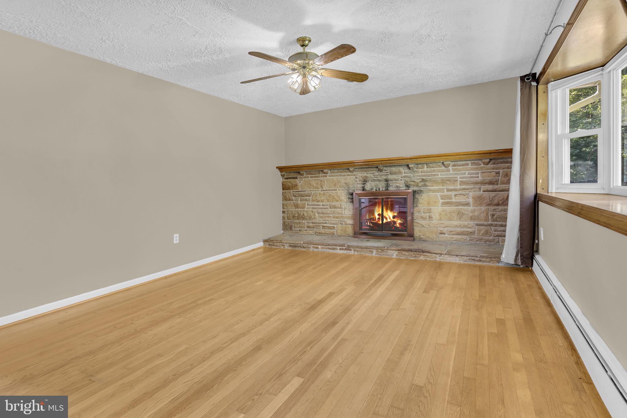 16500 Baden Naylor Road Brandywine, MD 20613 - Photo 6 of 37 wooden floor in an empty room with a fireplace