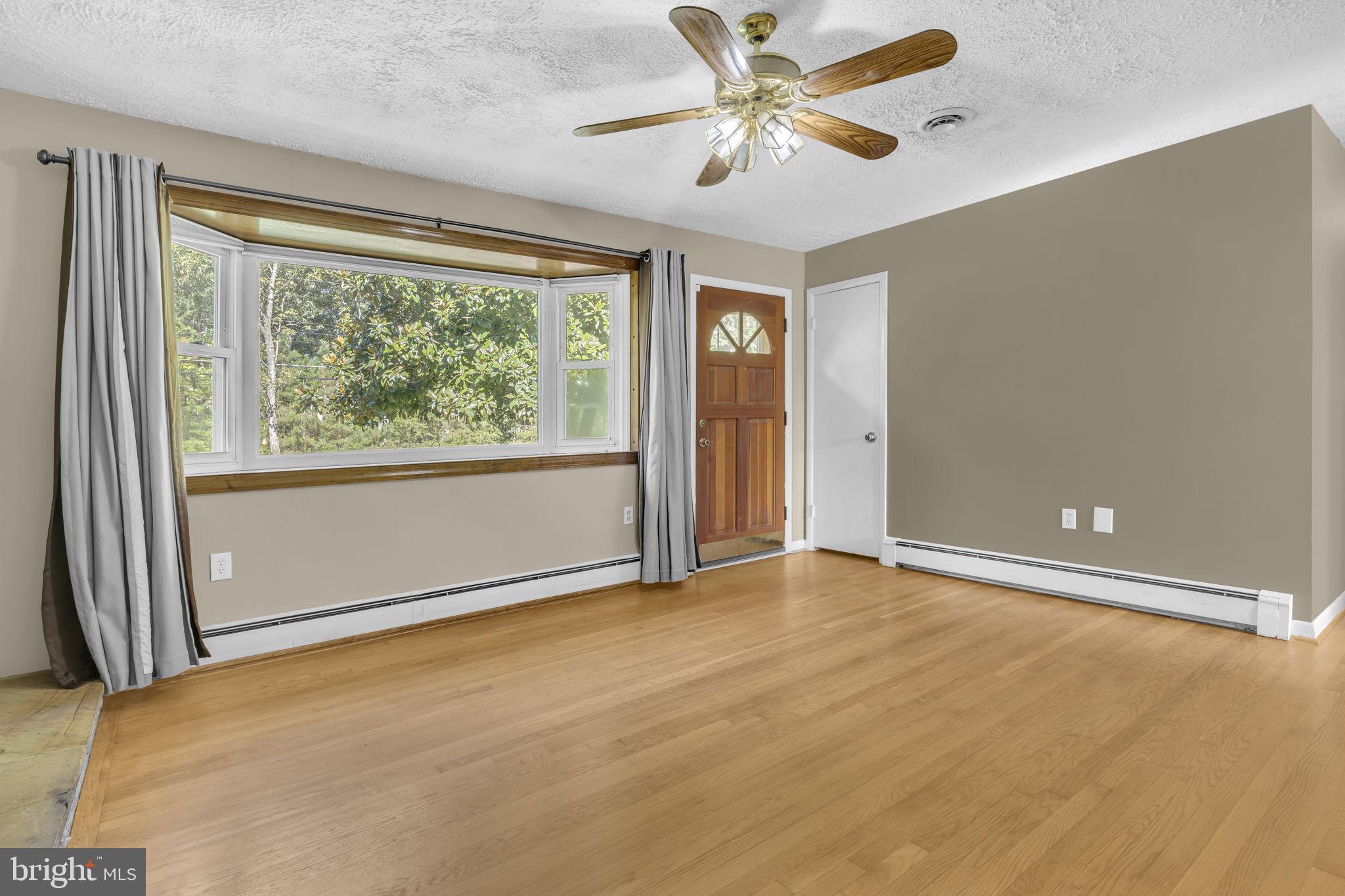 16500 Baden Naylor Road Brandywine, MD 20613 - Photo 8 of 37 an empty room with windows and ceiling fan