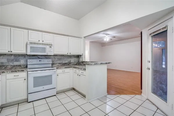 a kitchen with white cabinets