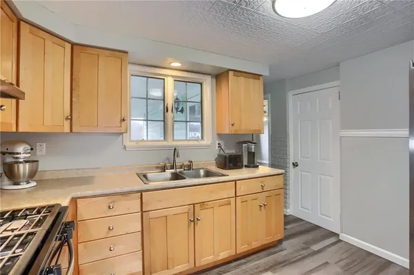 a kitchen with sink cabinets and window