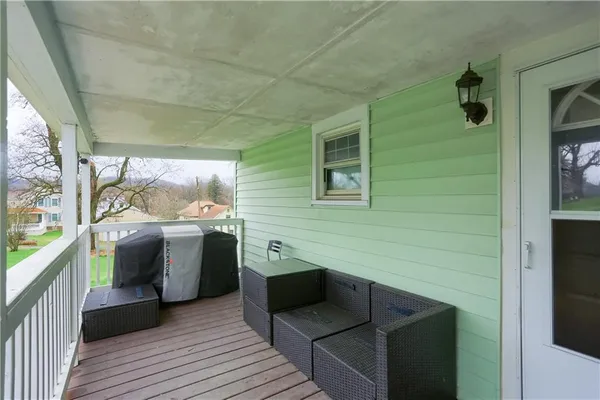 a view of a balcony with furniture and a window