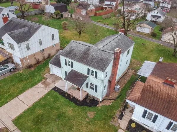 an aerial view of multiple houses with yard
