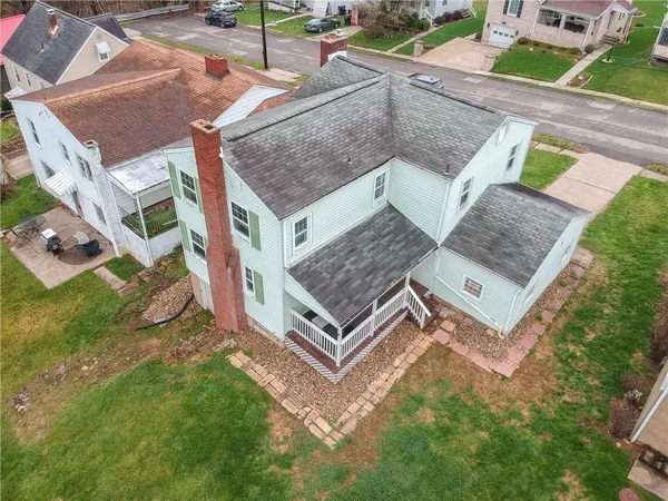 an aerial view of a house with a yard