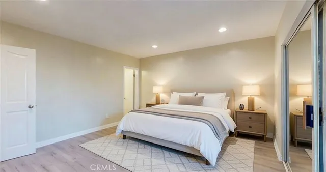 a bedroom with a bed and a night stand