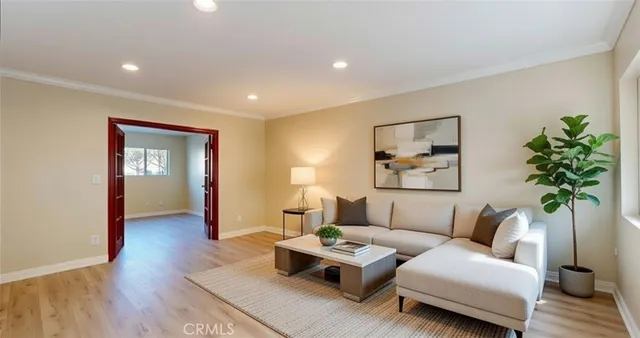 a living room with furniture and a potted plant